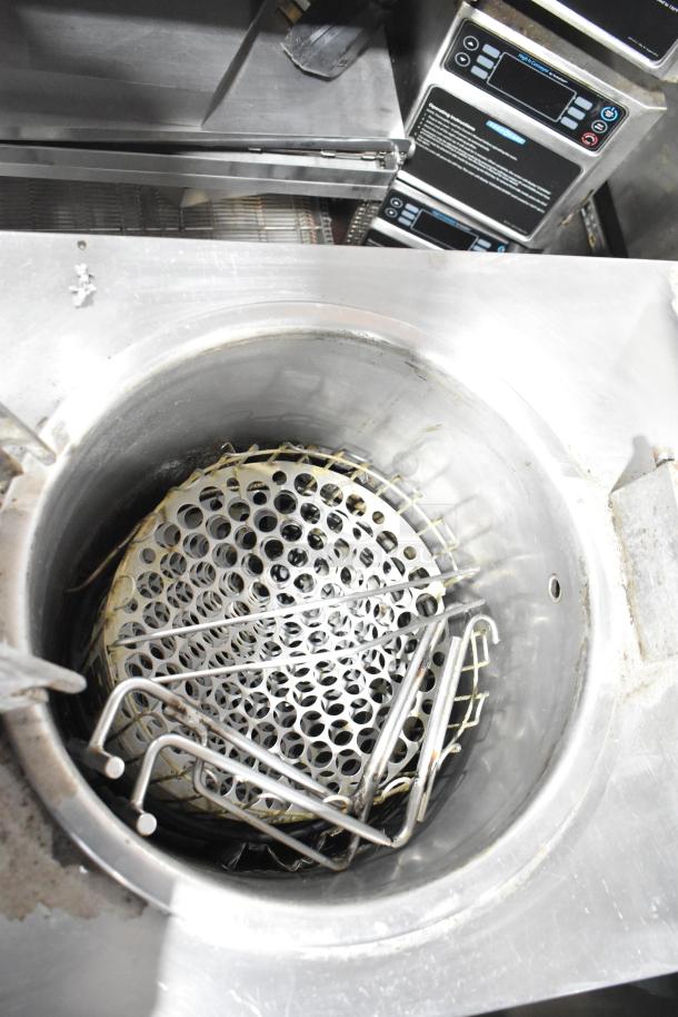 Commercial floor-style pressure fryer, stainless steel interior with wire racks, digital controls; used condition.