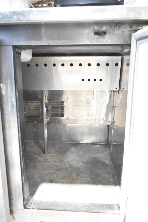 Everest EPR2 Commercial Sandwich Salad Prep Table interior view, showing stainless steel construction and ventilation slots.
