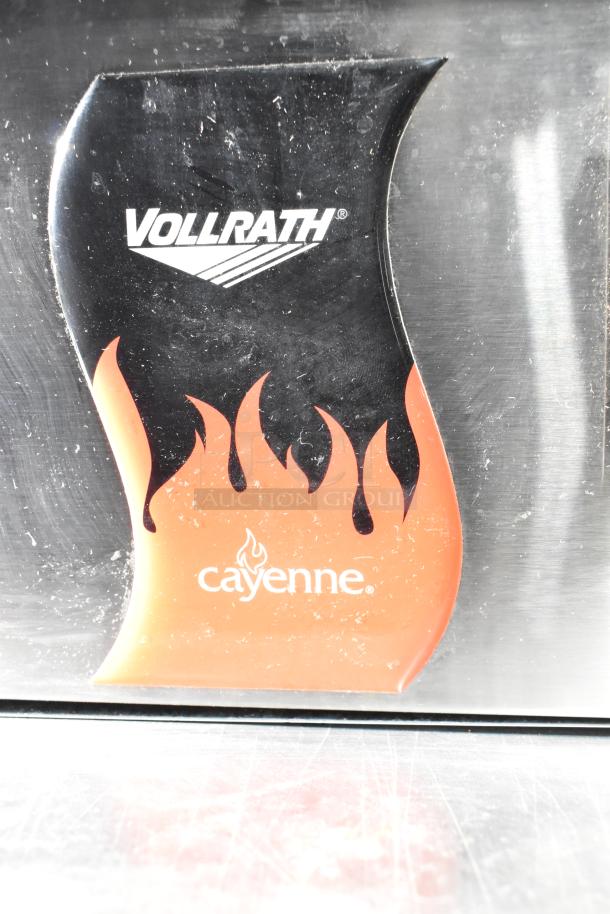 Vollrath Cayenne FTA 8024 commercial griddle label with flames design. Model 40716, 220V, 1 Phase. Brand logo visible.