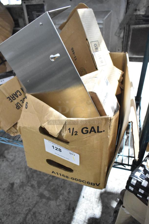 Box with assorted items including San Jamar lid dispenser and faucet. Visible markings note 1/2 GAL. Condition appears used.