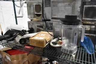 Lot of various items including a Poly blender pitcher, blue ice scooper, and TableCraft CRATE14 crate on metal shelf.