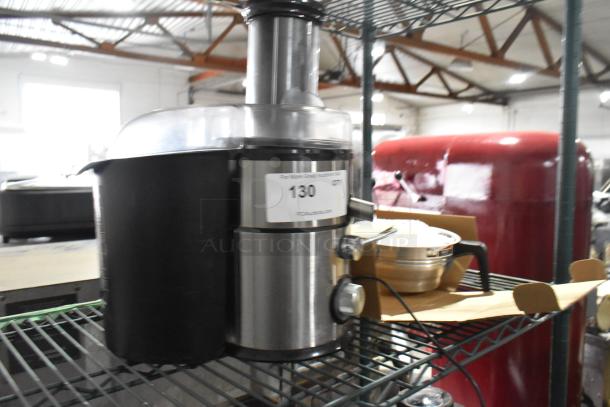 Countertop juicer with stainless steel finish, black container, visible auction tag marked "130".
