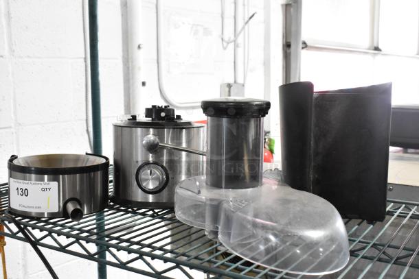 Stainless steel countertop juicer with power dial and spout; includes plastic components. Item shows light wear. Auction label: 130.