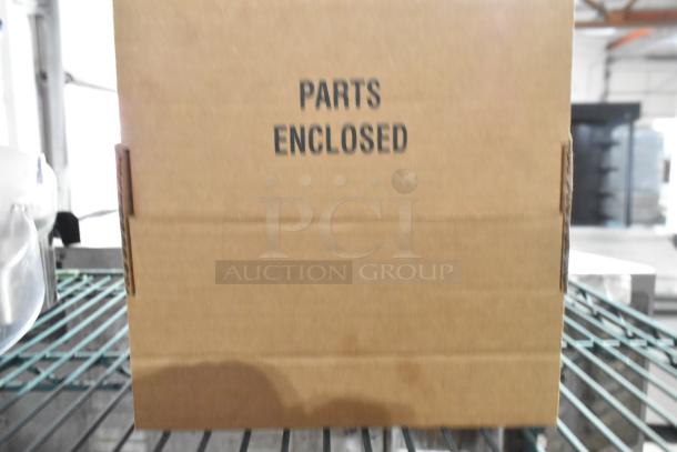 Cardboard box labeled "Parts Enclosed" for countertop juicer, indicating new or unused condition.