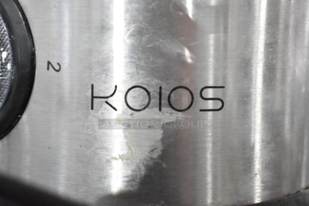 Stainless steel Koios countertop juicer, moderate wear, featuring power dial with "2" setting visible.