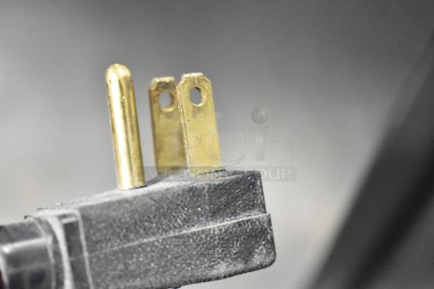 Close-up of a 115-volt plug for the 2016 True T-19F commercial freezer, showing prongs and black casing.