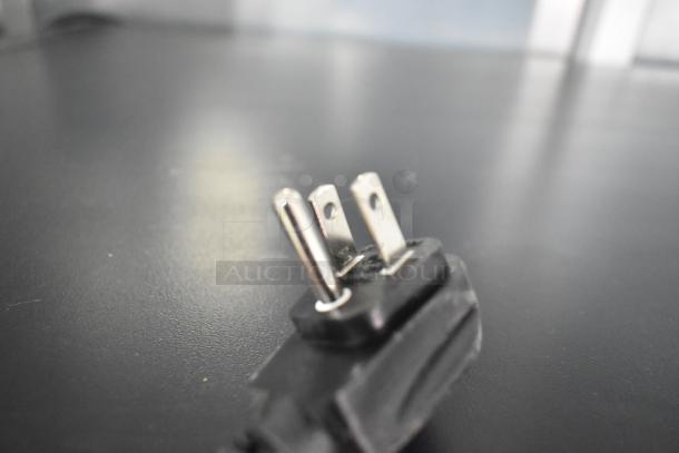 Close-up of a power plug for the QBD CD4154-HC Commercial 2 Door Reach In Cooler Merchandiser, 115 volts, 1 phase.