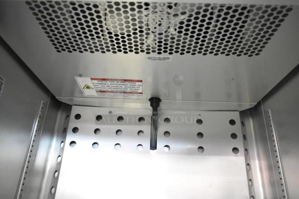 True T-19F-HC Freezer interior, stainless steel finish, with vented back panel and caution label. Model T-19F-HC, 115V, 1 Phase.