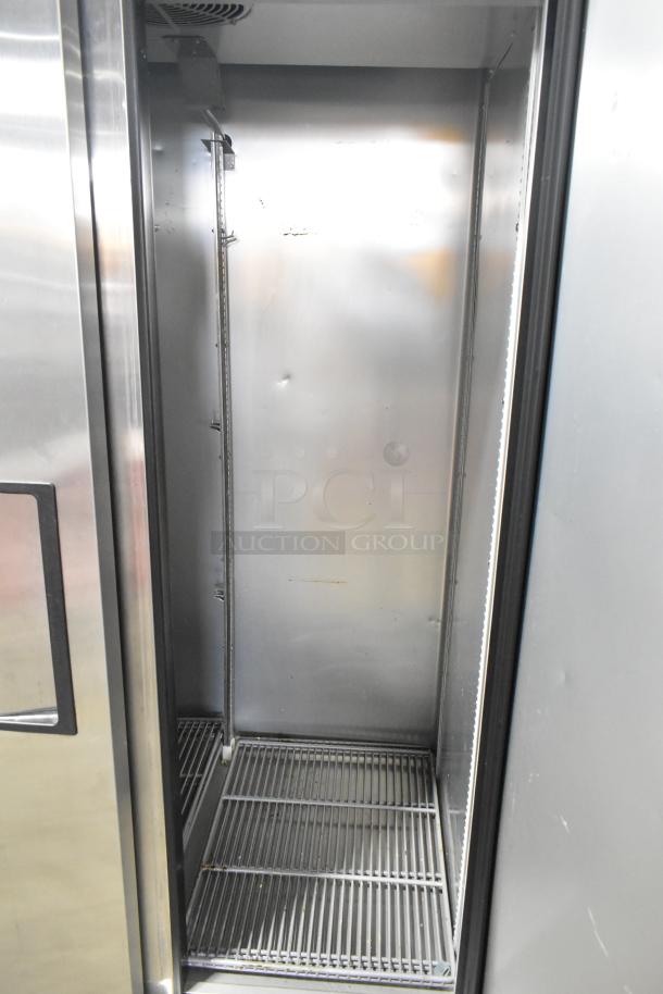 2021 True T-35-HC commercial 2-door reach-in cooler, 115V, 1 phase, in good condition with steel shelving.