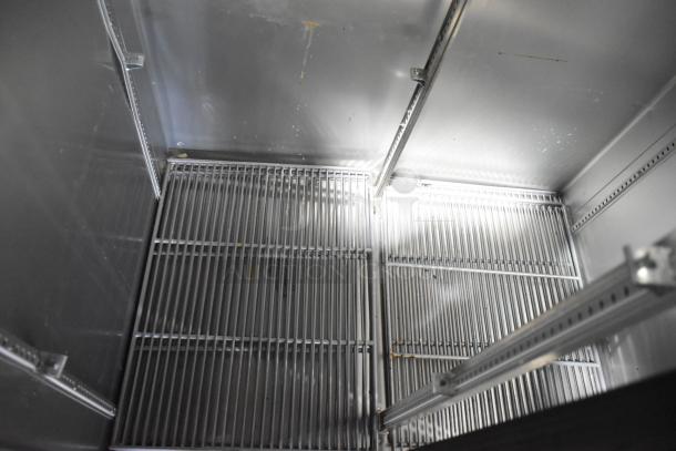 Interior view of a 2021 True T-35-HC Commercial 2 Door Reach-In Cooler, showing metal shelving and sturdy construction.