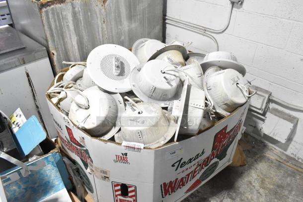 Box of 80 Wheelock CBB-8 speakers, white, used condition. Speakers have visible wiring and mounting hardware.