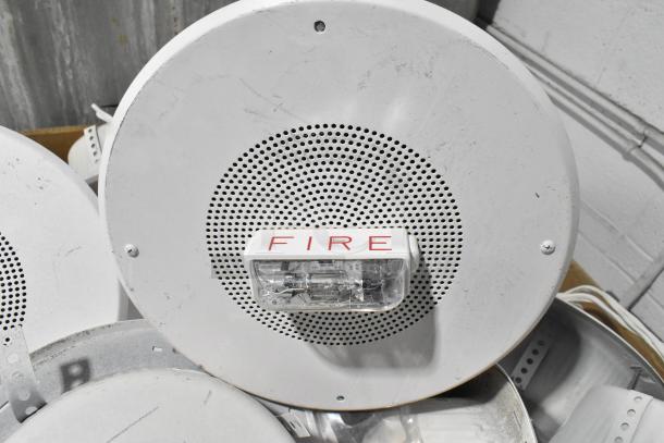 80 Wheelock CBB-8 speakers in used condition, with "FIRE" labeled alert light, sold in bulk for auction.