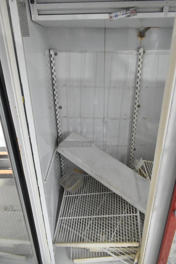 Kelvinator Commercial 2 Door Reach In Merchandiser, interior view showing wire shelves, fair condition, shelving misaligned.