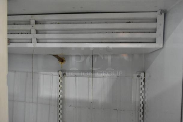 Kelvinator Commercial 2 Door Reach-In Merchandiser interior. Features shelving and cooling unit. Moderate wear visible.