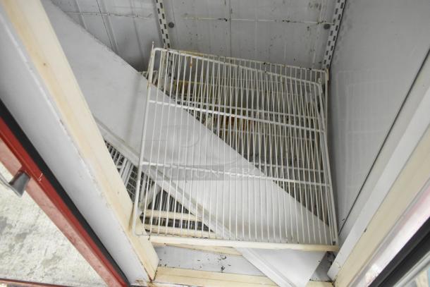 Kelvinator Commercial 2 Door Reach In Merchandiser, interior shelves missing, visible wear and rust, needs maintenance.