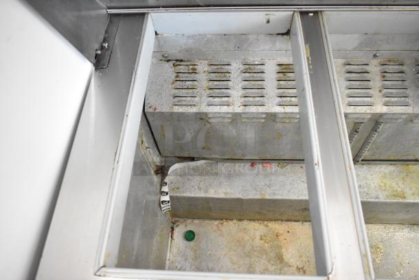 Continental SW48-18M prep table interior view, showing slots and wear. Used condition. Suitable for commercial kitchens.
