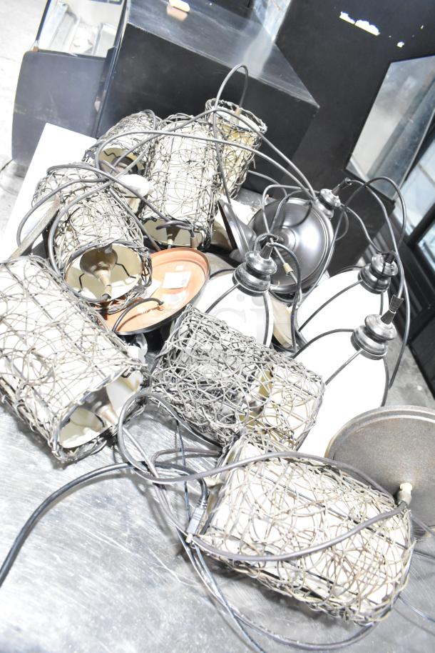 11 assorted light fixtures with wire mesh designs, varying conditions. Includes wiring and mounting components. Auction lot.