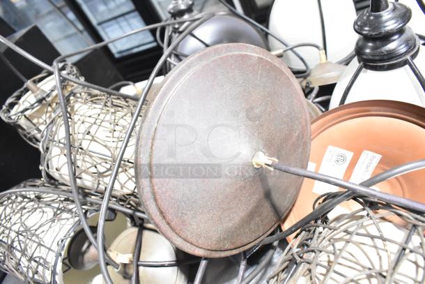 11 various light fixtures with metal and glass features, some with visible wiring. Includes assorted designs and finishes.