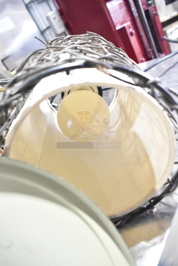 11 various light fixtures with metal wire detailing, shown close up. Items in used condition. Offer is 11 times your bid.