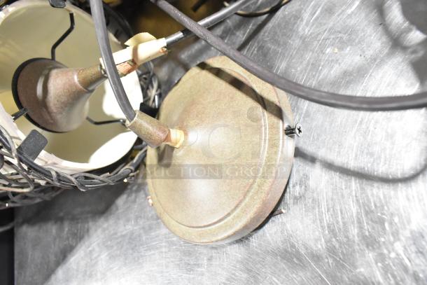 11 various light fixtures with metal bases and wiring, auctioned as a lot. Some assembly parts visible, condition appears used.