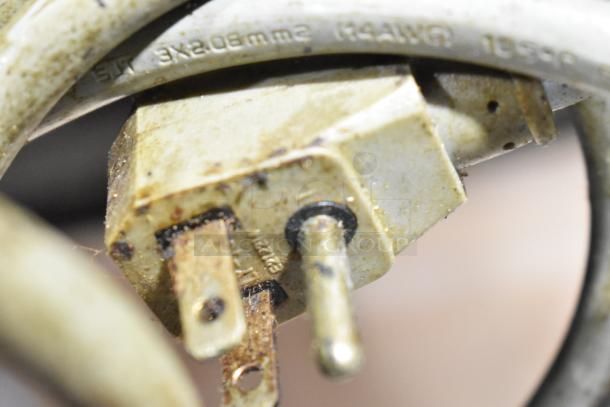 Close-up of worn electrical plug of Centaur CUF-48 Commercial Undercounter Freezer. Visible rust and grime on plug.