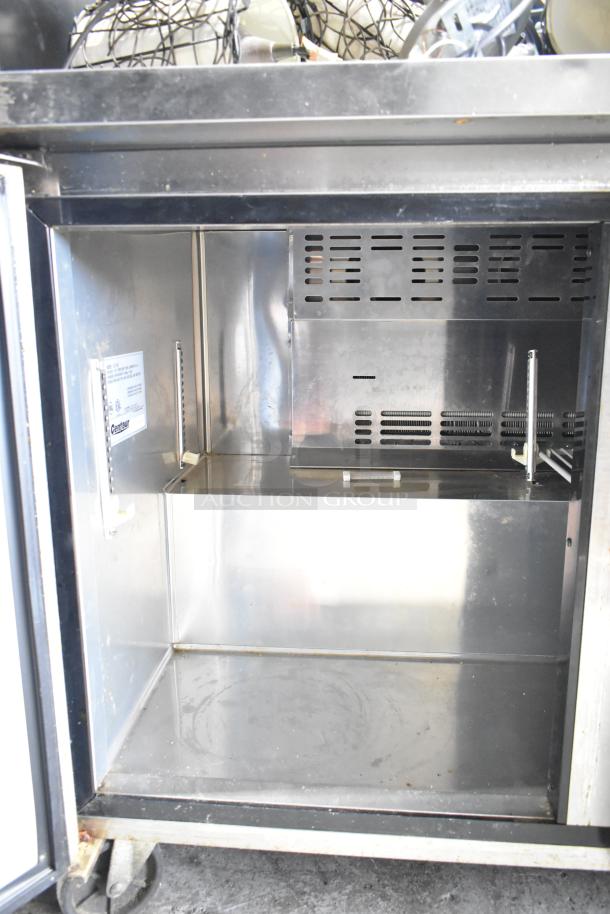 Centaur CUF-48 undercounter freezer, 2 doors, 115V, shown open with stainless interior. Model label visible inside. Used condition.