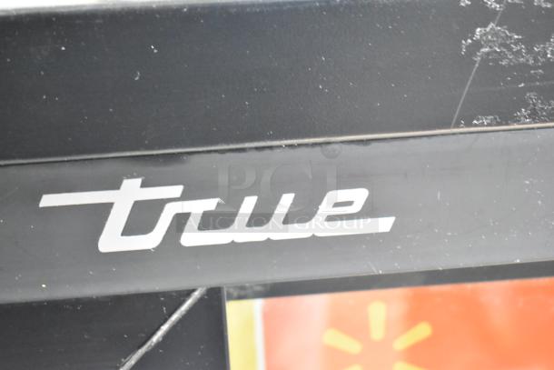 2018 True GDM-41SL-48-HC-LD commercial cooler with 2 glass doors, black finish, and True logo, showing mild wear.