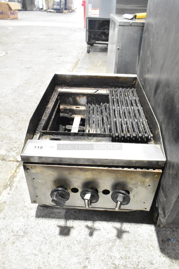 Commercial countertop gas charbroiler grill with three control knobs, steel exterior, and visible wear.