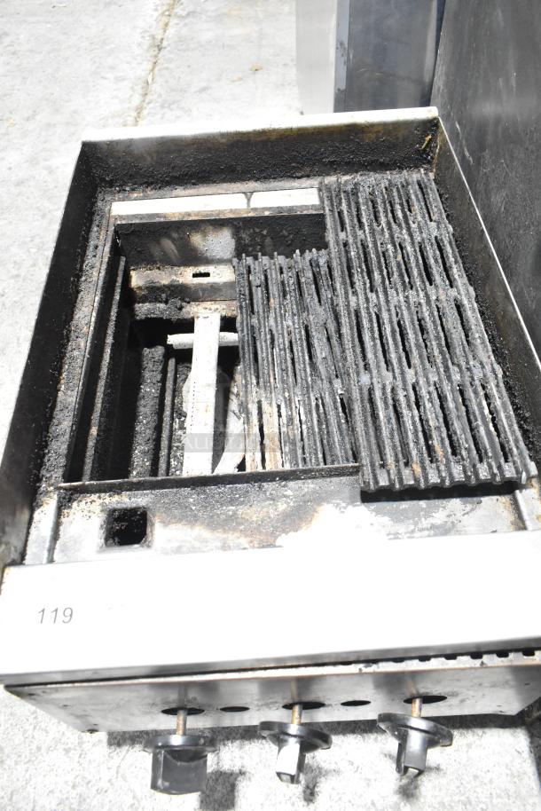 Commercial countertop gas charbroiler grill with metal grates and control knobs. Used condition with visible wear.