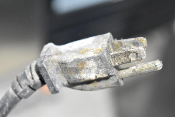 Close-up of a power plug, part of the Hatco HDW-2 Commercial 2 Drawer Warming Drawer. The plug appears worn and dusty.