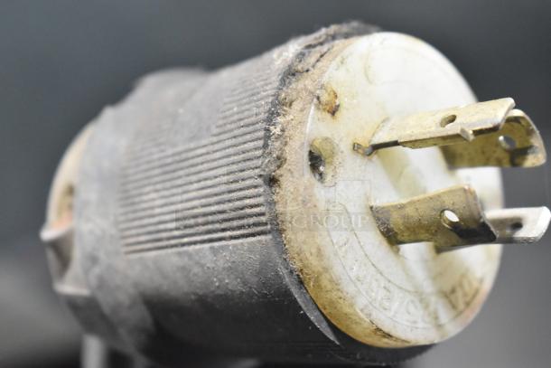 Close-up of a power plug likely from a Federal Industries RSSM460SC Merchandiser, showing wear and dust.