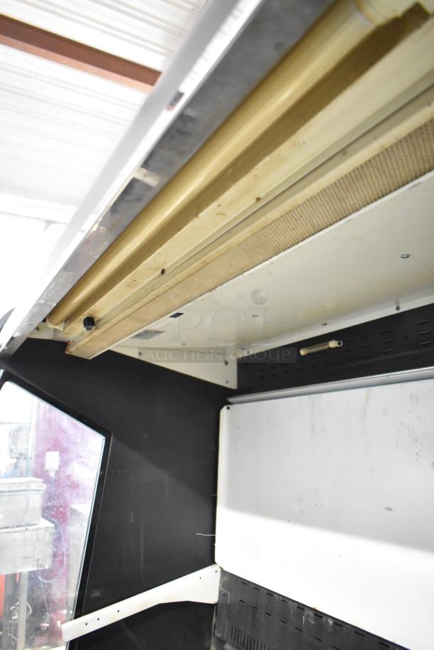Federal Industries RSSM460SC Grab N Go Merchandiser interior. Visible shelving system and lighting. Appears used.