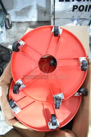 4 red poly round trash can dollies, each on commercial casters, in excellent condition, boxed ready for auction.