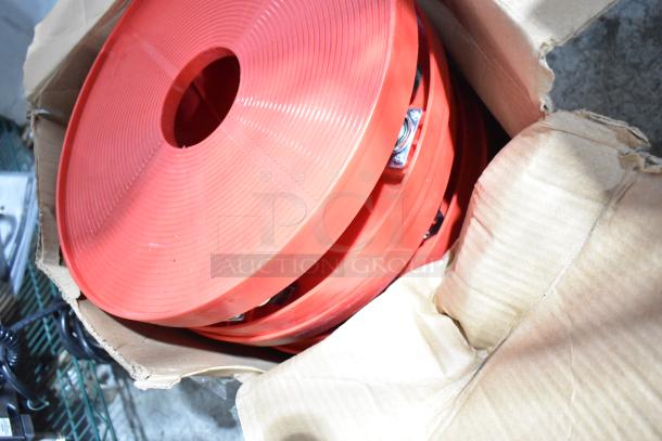 Four red poly round trash can dollies with commercial casters, in a partially opened cardboard box.