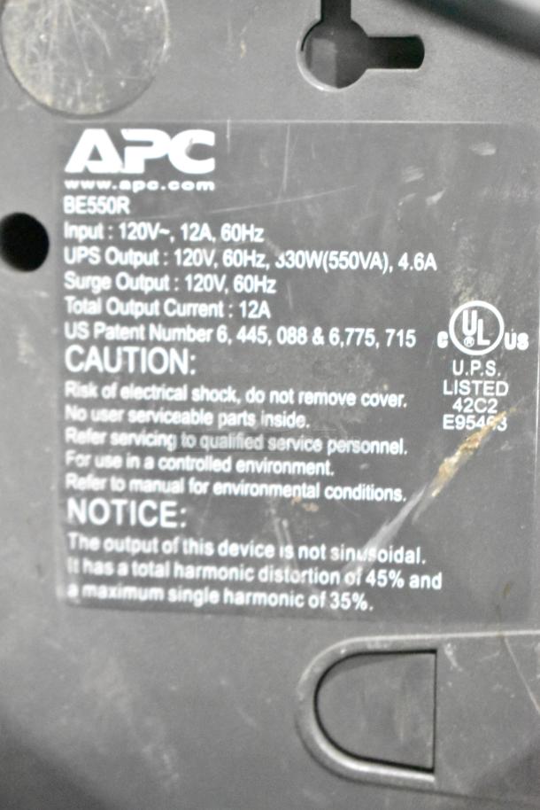 APC BE550R UPS, 120V, 12A, 60Hz; 330W(550VA) output. Features caution and UL marks. Scratched surface.