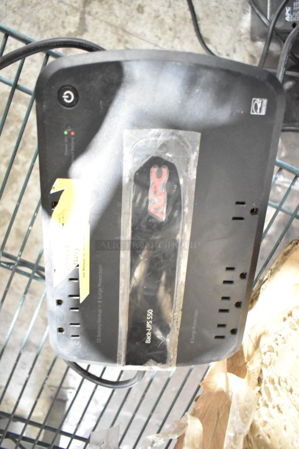 APC Back-UPS 550, used condition, with visible power button, outlets, and branding. Yellow tag notes battery and surge protection.