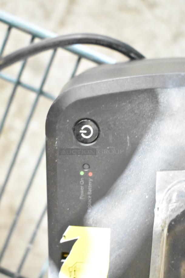 APC Uninterruptible Power Supply with power button and status lights indicating power and battery status, gently used.