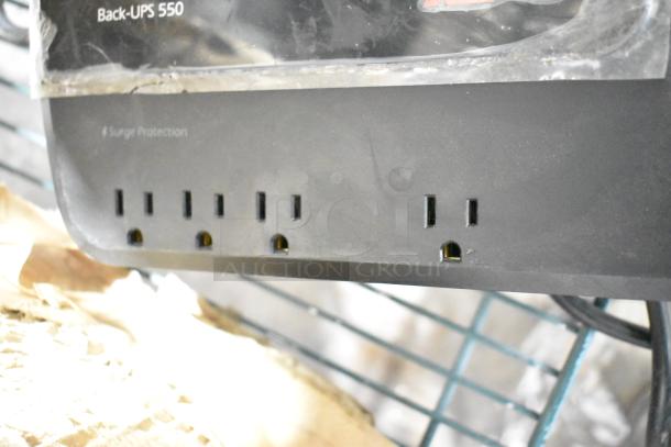 APC Back-UPS 550, featuring multiple outlets and surge protection. Visible wear on the casing.