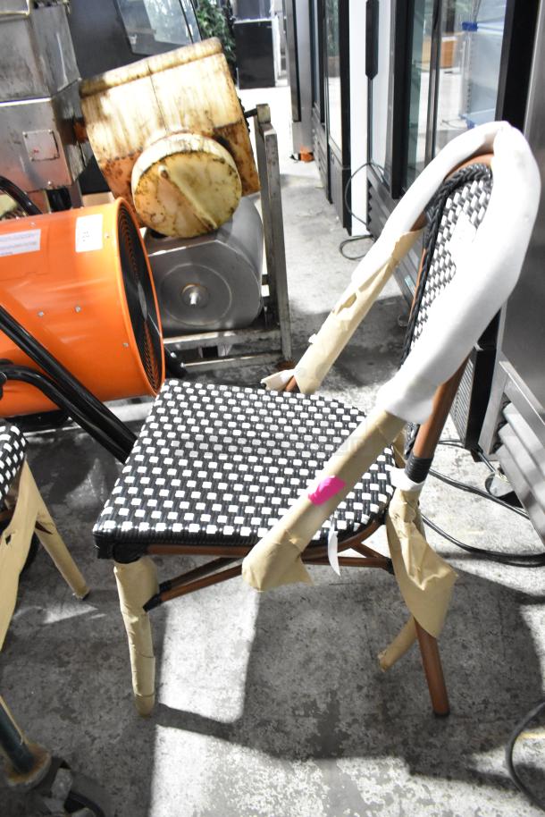 2 new Lancaster Table & Seating Bistro black & white checkered rattan outdoor side chairs, scratch and dent condition.