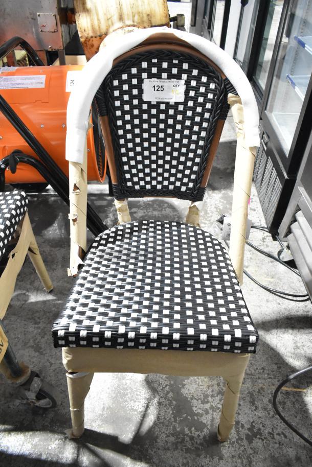 Brand new Lancaster Table & Seating 427CSRTBSBKW bistro chair. Black and white rattan weave. Scratch and dent condition.