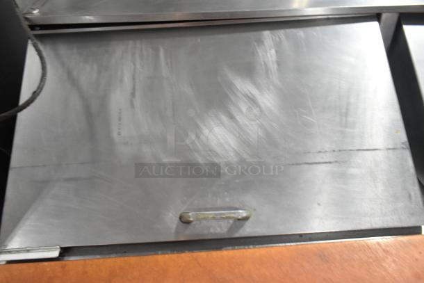 Beverage Air commercial prep table with stainless steel surface and handle, used condition, designed for sandwiches and salads.