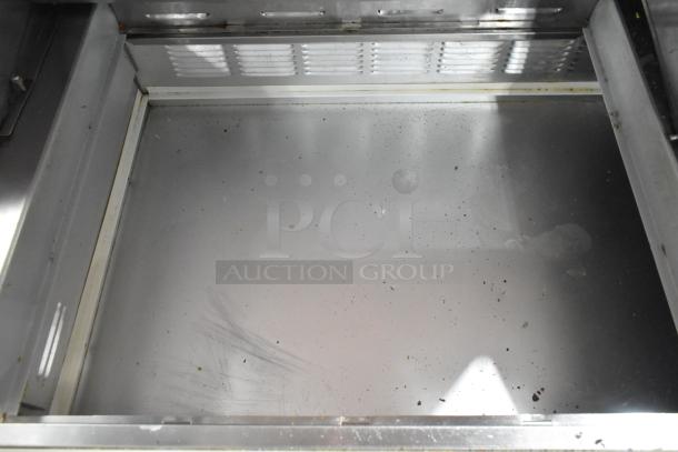 Beverage Air sandwich salad prep table, stainless steel, interior view with visible wear, 115 volts, commercial casters.