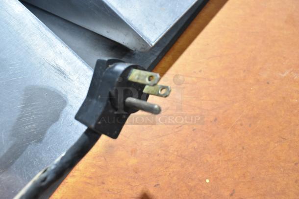 Beverage Air commercial prep table power cord, 115 volts, 1 phase, black plug on wood surface.