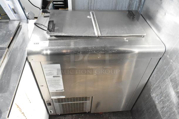 C Nelson BS 2 commercial chest freezer, stainless steel, 115 volts, 1 phase. Features visible labels and minor surface wear.