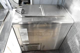 C Nelson BS 2 commercial chest freezer, stainless steel, 115 volts, 1 phase. Features visible labels and minor surface wear.