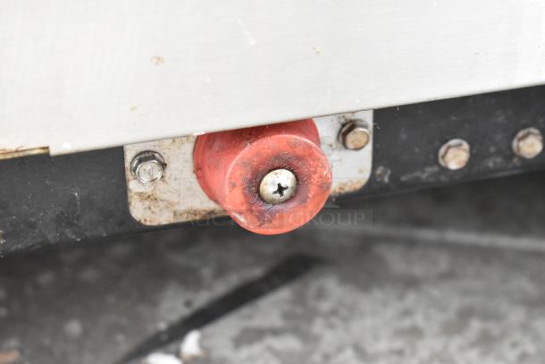 Close-up of a rusted hinge and screw on a C Nelson BS 2 Commercial Chest Freezer. Visible signs of wear.