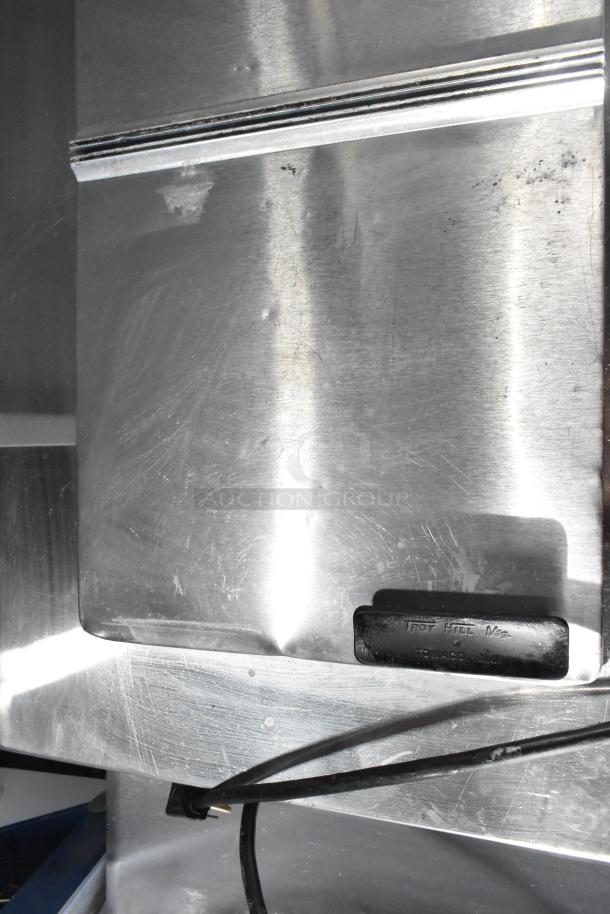 C Nelson BS 2 commercial chest freezer, stainless steel, 115 volts, 1 phase, visible wear, serial tag shows manufacturer info.