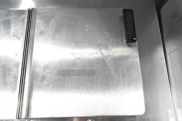 C Nelson BS 2 Commercial Chest Freezer, stainless steel, 115 volts, 1 phase. Visible handle, surface scratches.