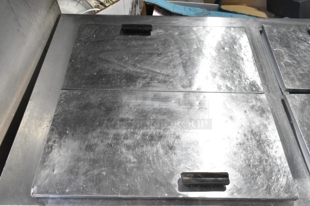 Excellence HFF-12-HC commercial chest freezer with three center hinge lids. Visible wear on stainless steel surface. 115 volts, 1 phase.