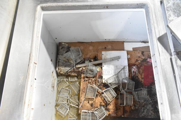 Excellence HFF-12-HC commercial chest freezer, visible wear and debris inside. Features 3 center hinge lids, 115V, 1 phase.